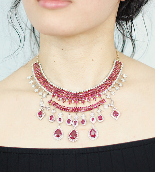 A7 Ruby Necklace by JewelCreationsNY featuring a vibrant red ruby pendant on a delicate silver chain.
